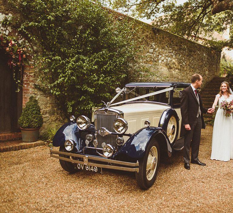 Navy and cream vintage wedding car for the bride and groom at classic wedding 