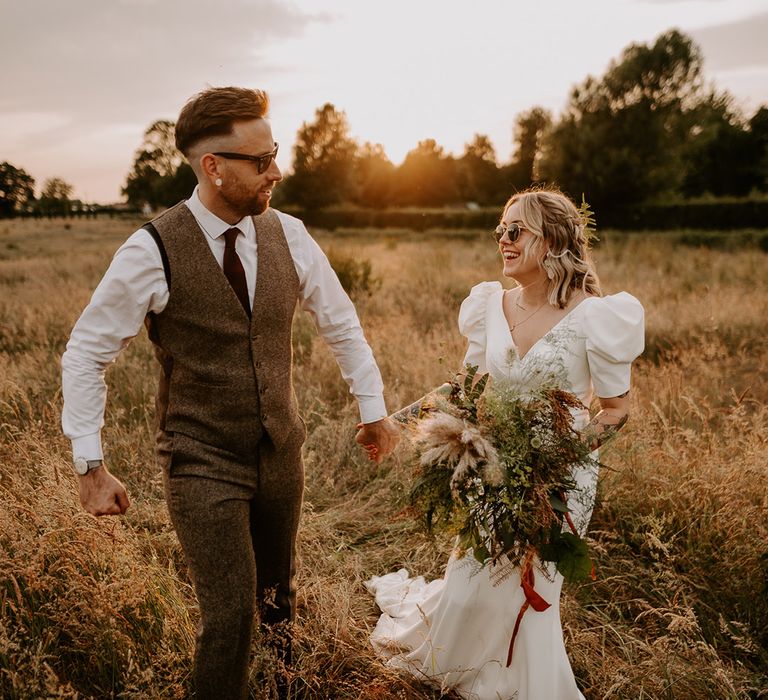 Golden hour wedding photo of the bride and groom as the sun begins to set 