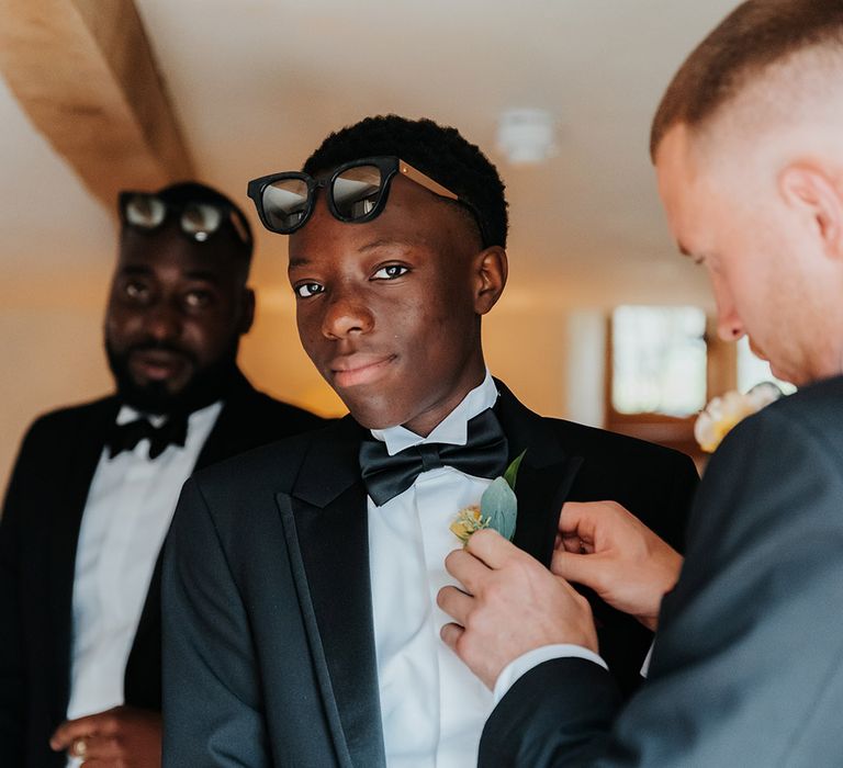 Groomsmen in black tie wedding outfit with sunglasses at classic Dewsall Court wedding 