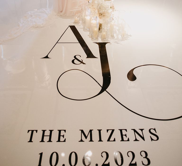 Personalised black and white wedding dance floor with white wedding cake 