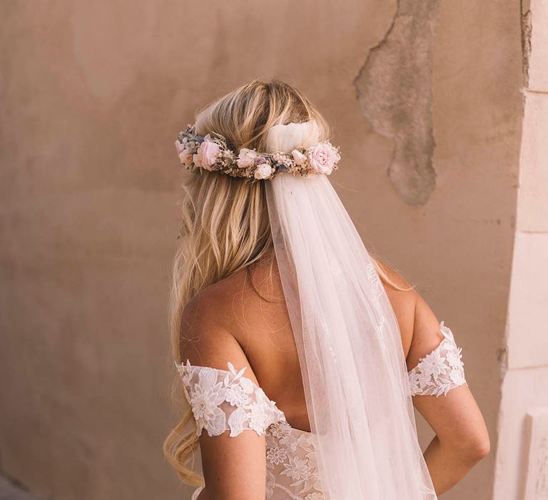 Bride in off the shoulder boho gown with flower crown and personalised veil 