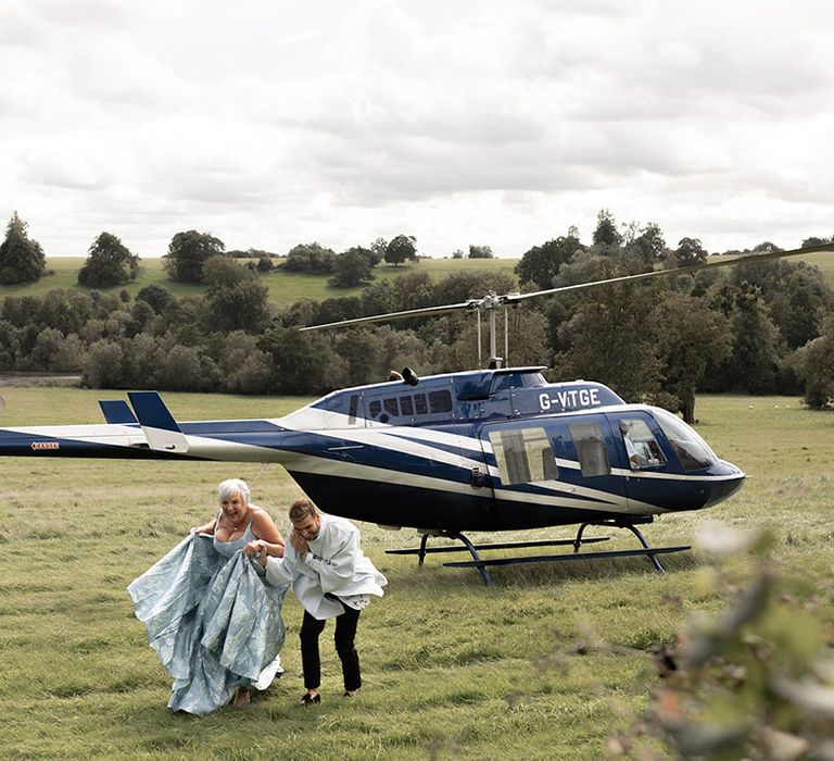 Helicopter entrance for the two groom to their outdoor gay wedding 