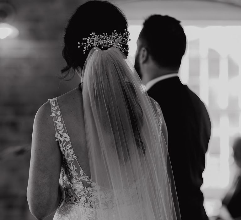 Bride wearing pearl crystal hair piece and veil 