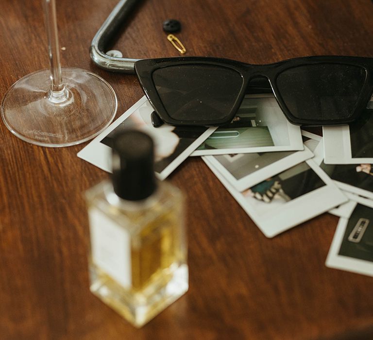 Black sunglasses with polaroid pictures and perfume 