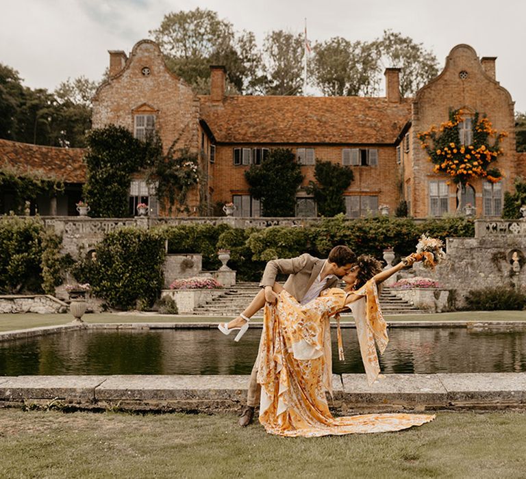 The bride and groom walk around their wedding venue, Port Lympne in Kent 