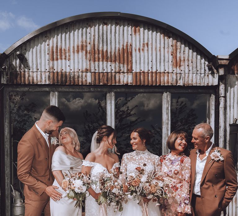 Rustic barn wedding with the parents of the bride in outfits that match the neutral wedding theme 