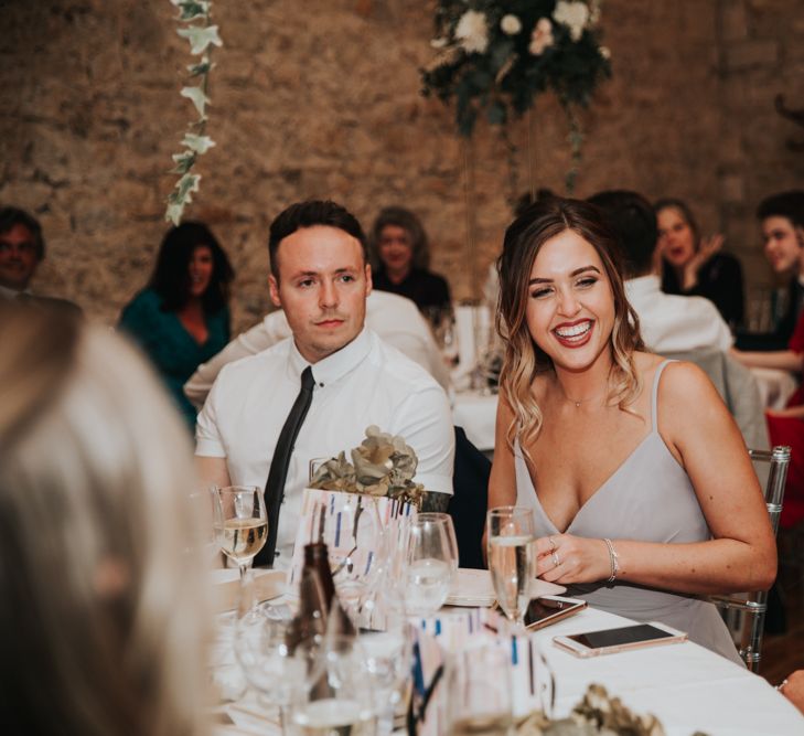 Wedding guest smiling at Notley Abbey reception 