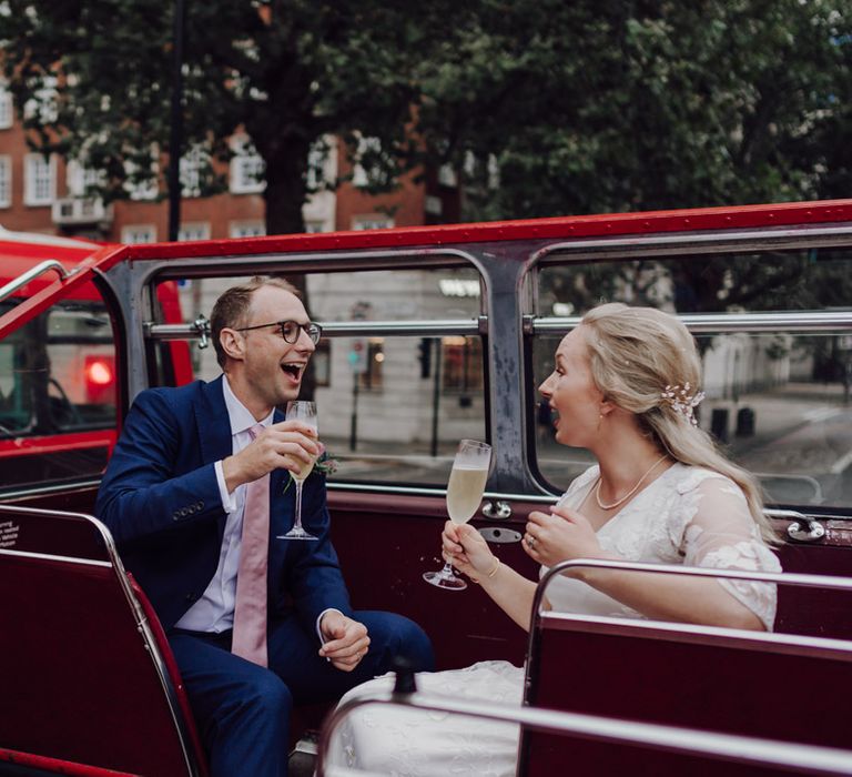 Bride and groom cheers on London wedding bus