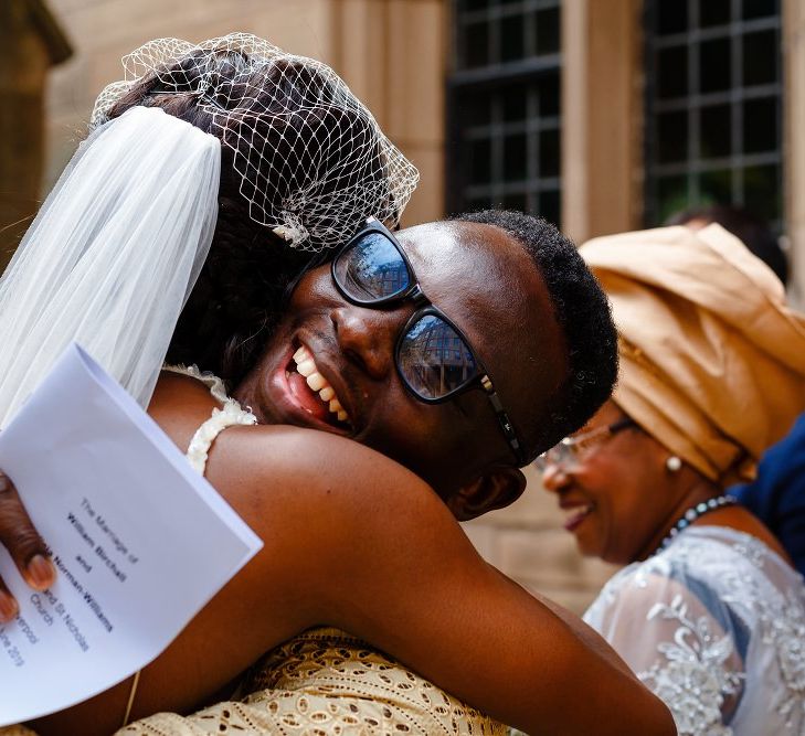 Bride hugging wedding guests