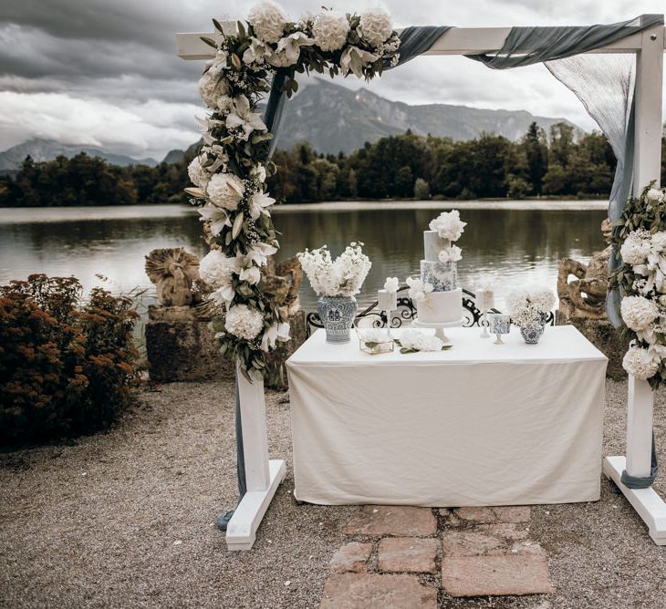 Dessert table full of blue and white Chinese potter, white flowers and cakes 