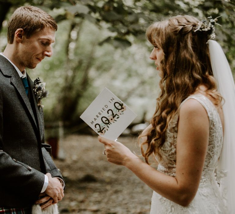 Bride and groom stand with each other as they read special words together