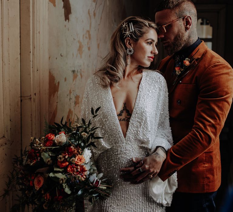 Groom in orange velvet jacket with bride in asos dress