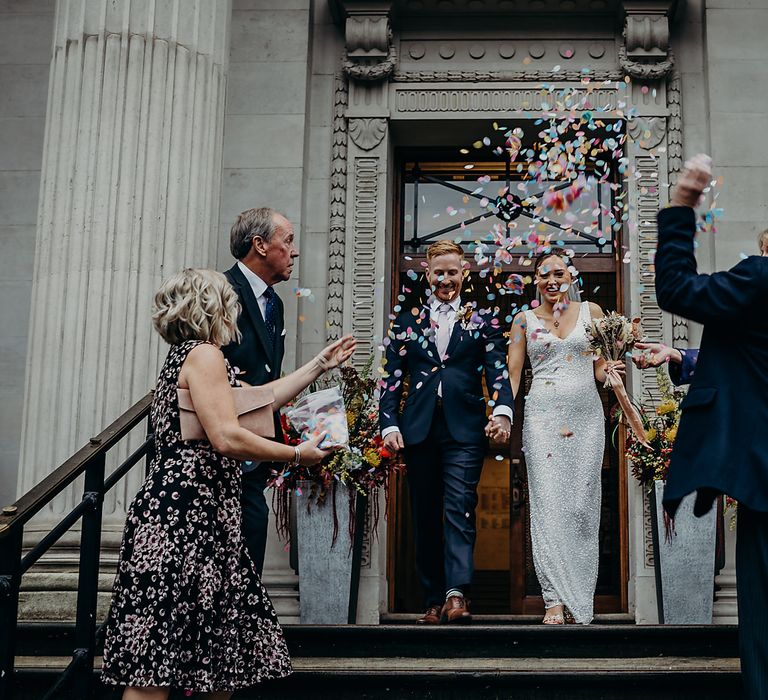 Bride and groom exiting their Old Marylebone Town Hall wedding 