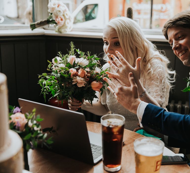 Bride shows wedding ring on Zoom call to family and friends