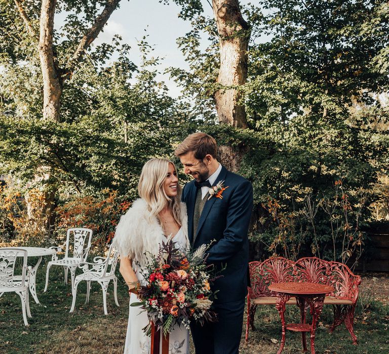 Bride & groom stand outside on wedding day 