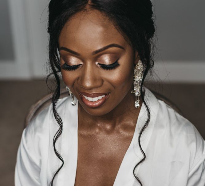 Beautiful Black bridal makeup with chandelier earrings, highlighter and shimmer eyeshadow 