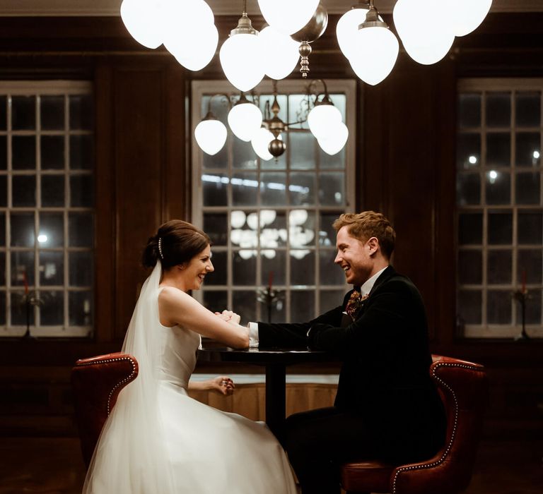 Bride and groom arm wrestling 