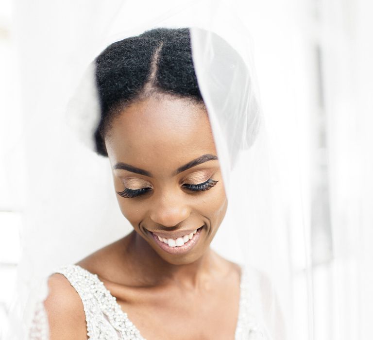 Bride wears Allure gown with sequinned bodice and veil