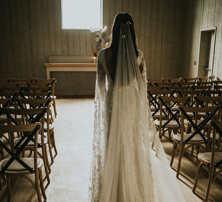 Bride in a long cathedral length veil and lace wedding dress at Primrose Hill Farm wedding venue 