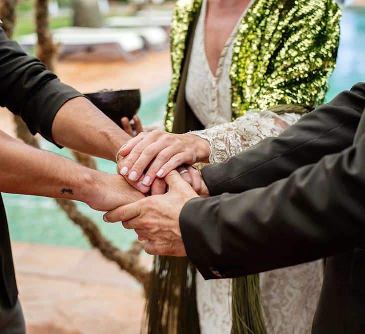 Close up of hands during wedding ceremony. Photography by Stephanie Shenton.