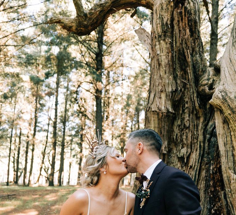 Bride clutches blush bouquet as she kisses new husband