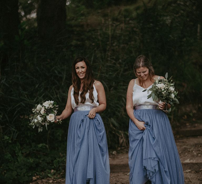 Bridesmaids wearing dresses with pale blue skirts and silver strappy tops