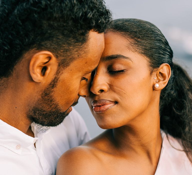 Bride leans in to kiss groom on their honeymoon