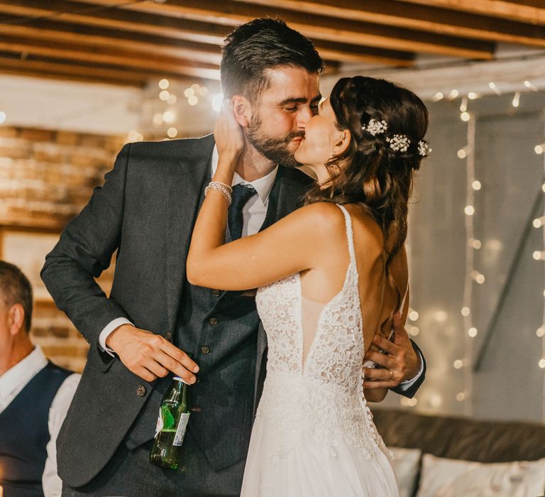 Bride & groom kiss during wedding reception at East Quay Venue