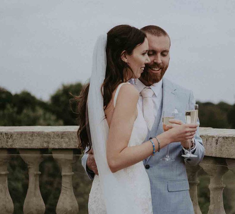 Bride and groom share a toast at Pylewell Park wedding