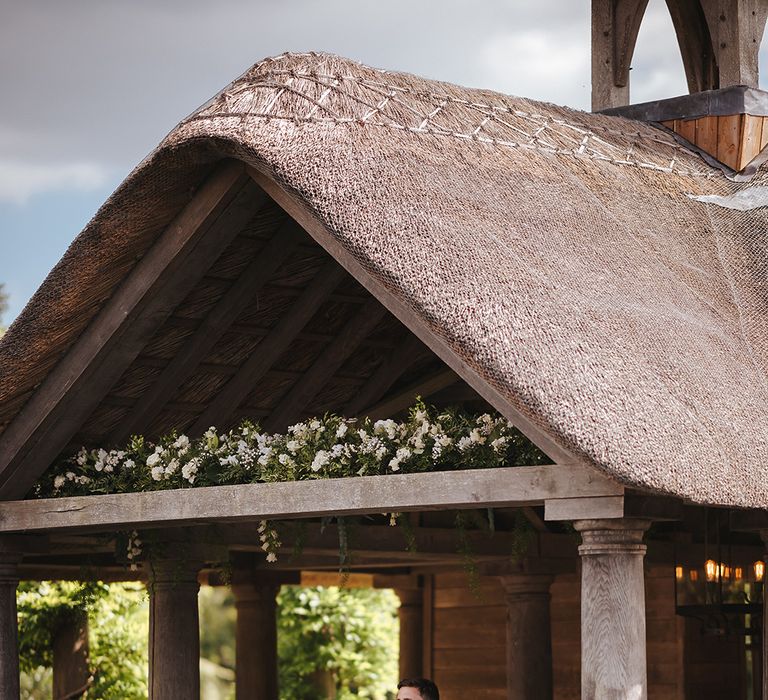 Bride & groom stand outdoors after their wedding ceremony 