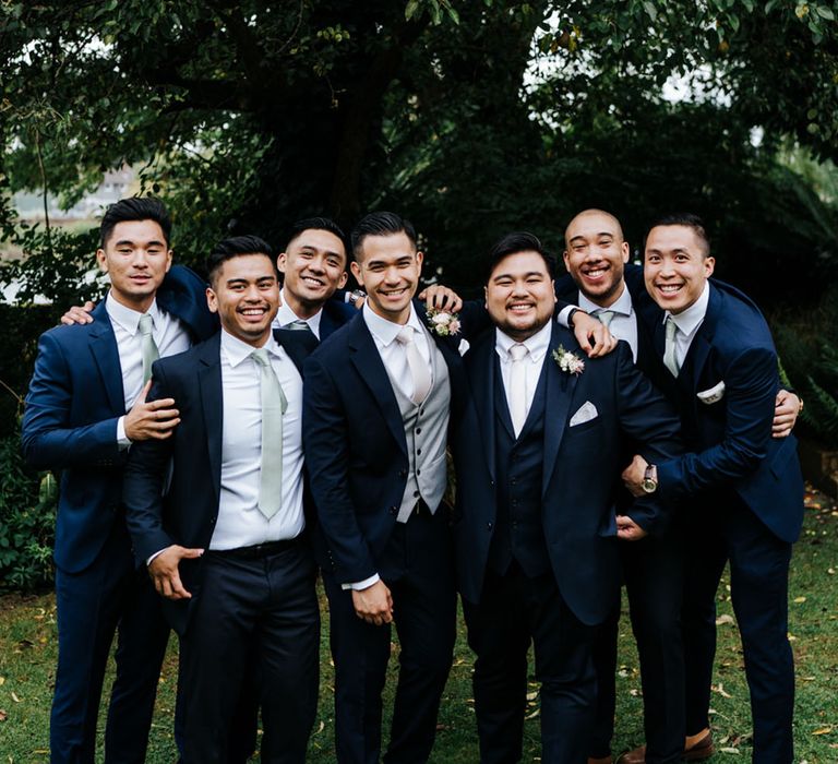 Groom and groomsmen in navy suits at Bingham Riverhouse