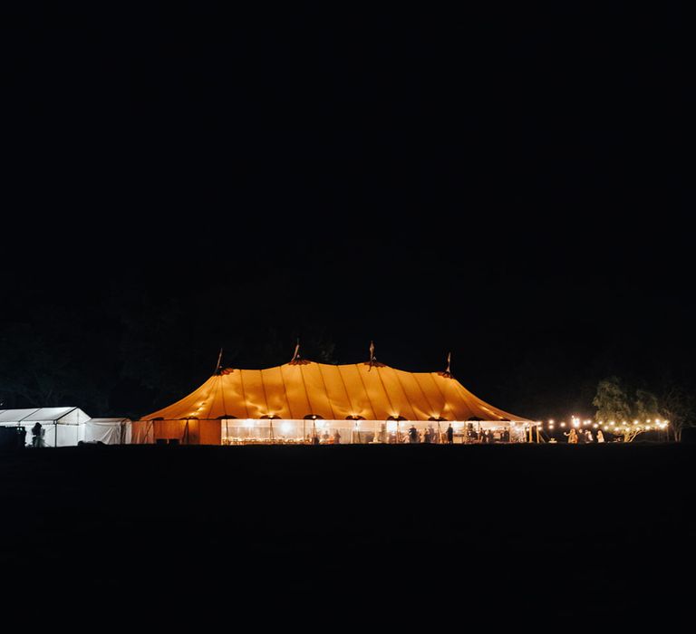 Exterior of sperry tent wedding reception in Hertfordshire at night