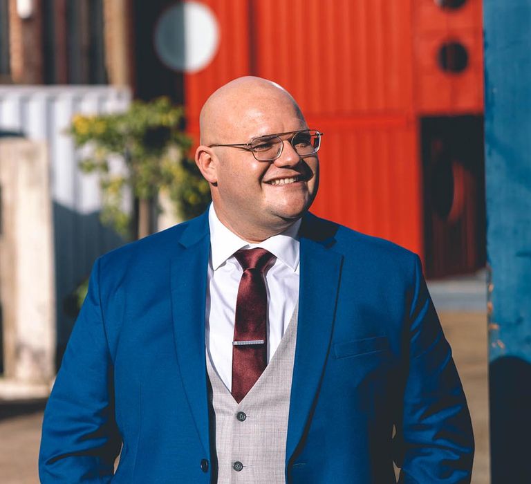 Groom in custom-made blue wedding suit 