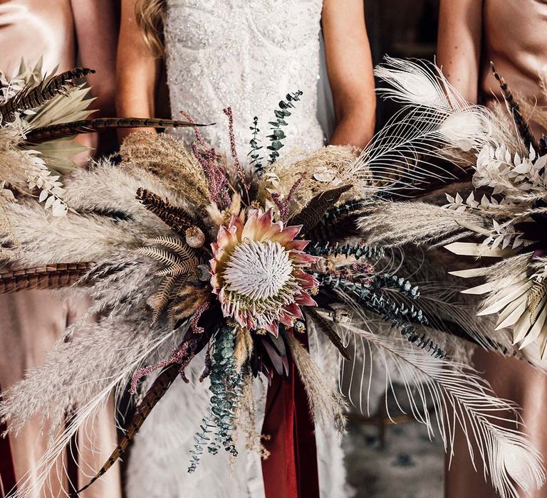 Statement bridal bouquet next to bridal bouquets filled with pampas grass