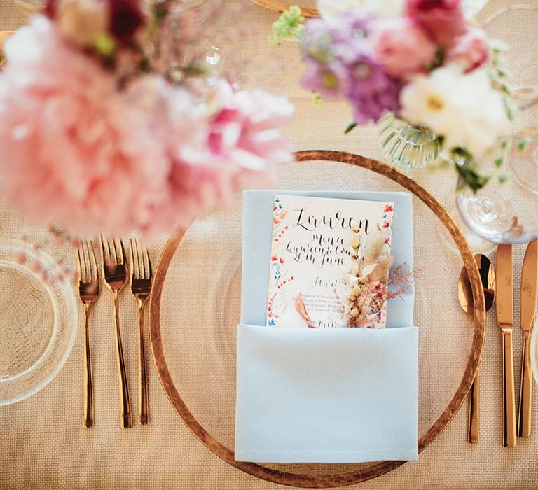 Gold styled wedding tablescape complete with colourful stationery and florals