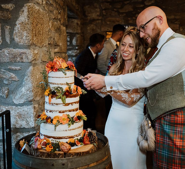 Bride & groom cut their wedding cake during reception