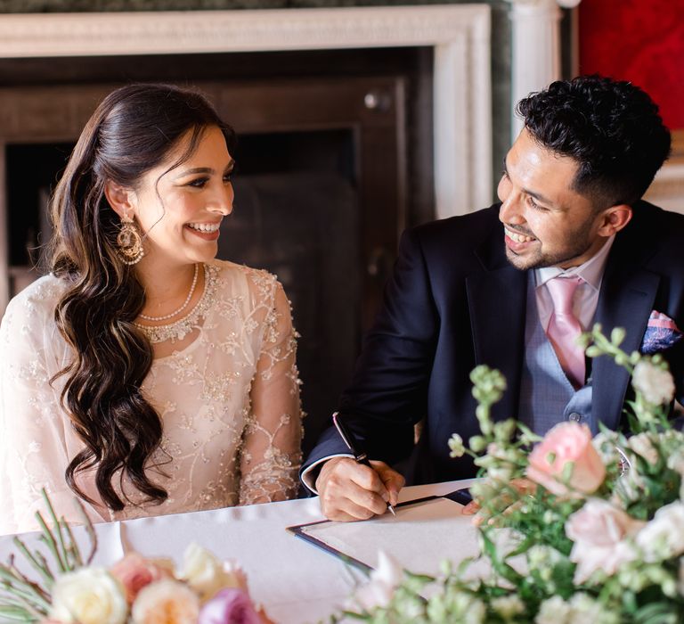 Bride & groom look lovingly at one another on their wedding day during reception