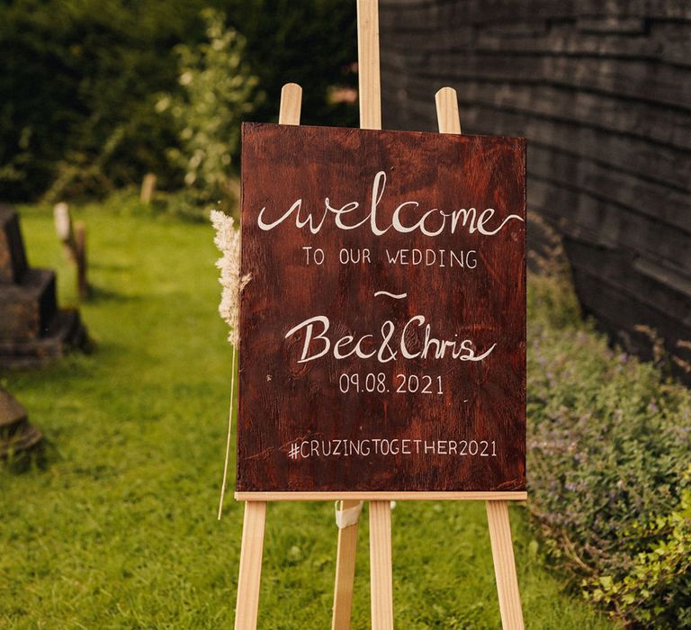 Personalised wedding sign complete with white italic writing and set on wooden easel  