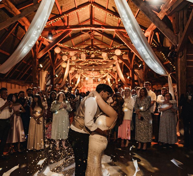 Bride & groom kiss during wedding reception at dry hire barn venue