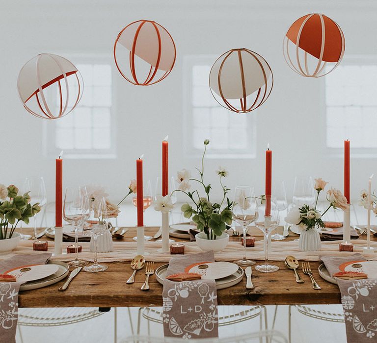 hanging paper lanterns over the reception table at asian wedding 