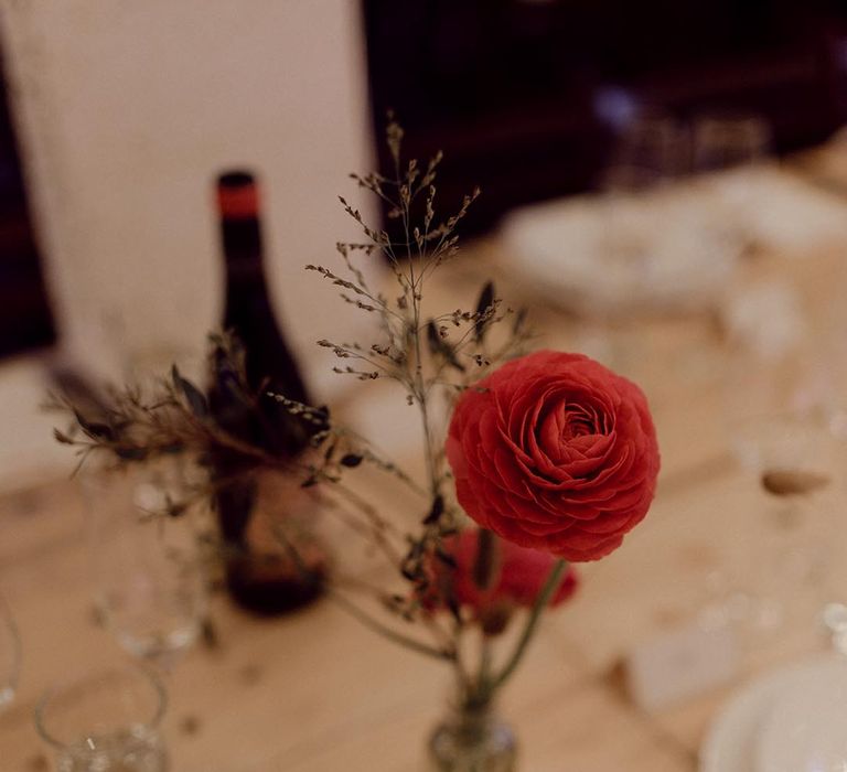 Simple red flower stem table decoration for minimal table setting style