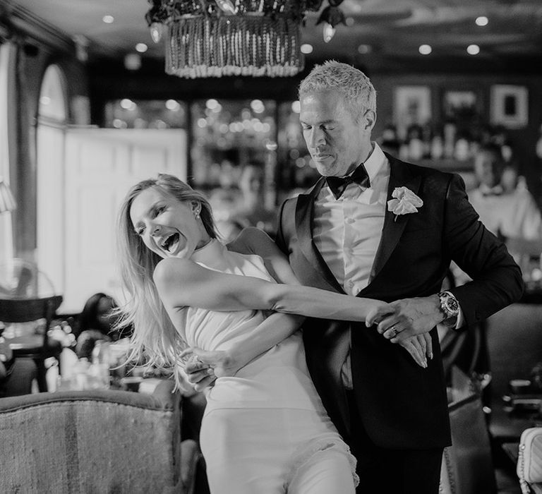 Bride and groom do their first dance in front of their guests for their intimate city wedding 