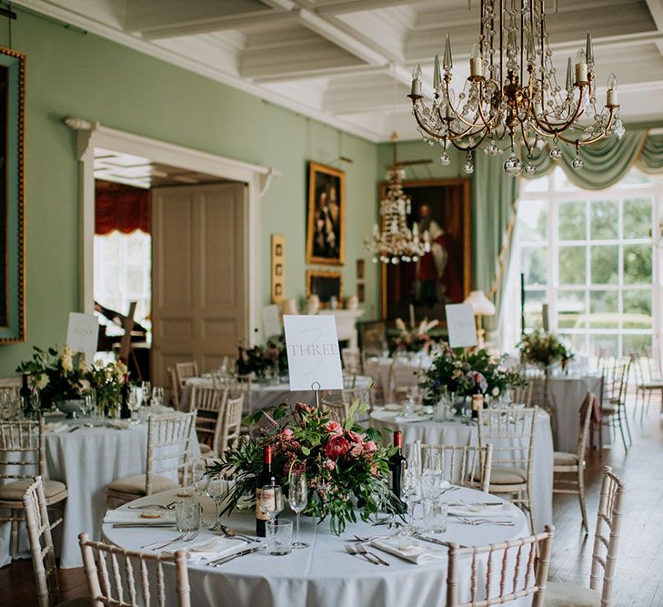 Birdsall House with regal and classic feel complete with antique paintings and white rounded tables with large bouquets