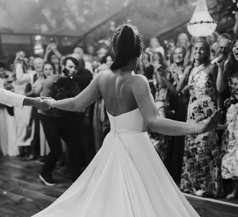 Bride in a strapless sweetheart Phillipa Lepley wedding dress doing her first dance 