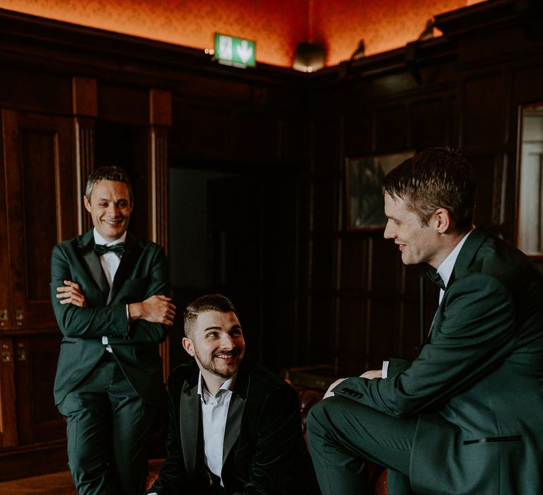 Groom and groomsmen in green suits for the boho wedding 