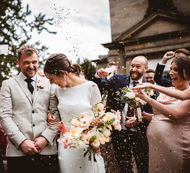 Bride and groom leaving The Orangery Ingestre wedding venue doing confetti walk 