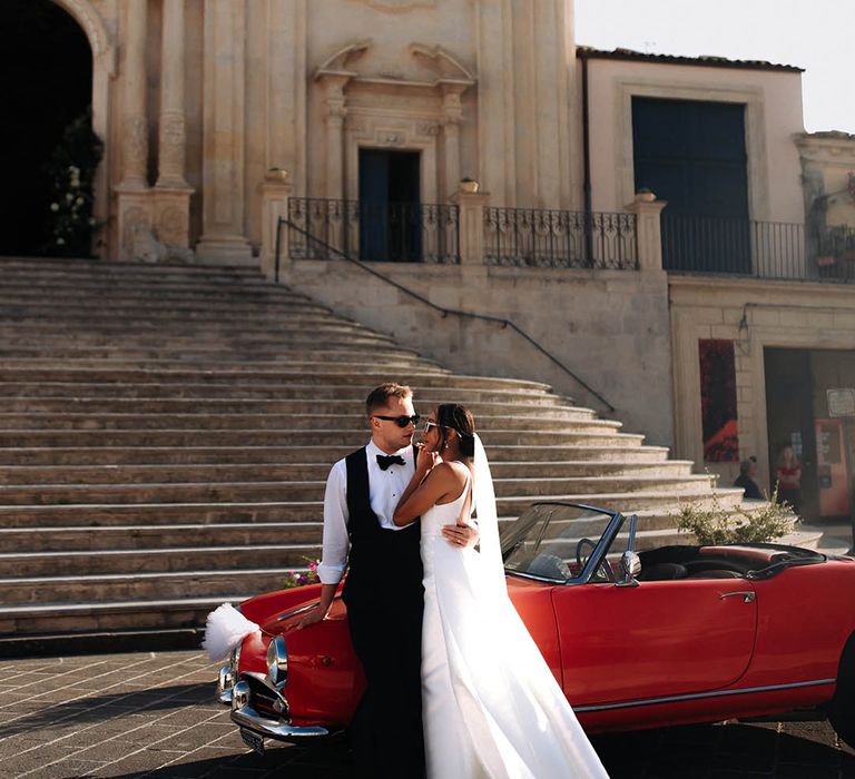 destination wedding with red wedding car and bride in Jane Hill Bridal gown 