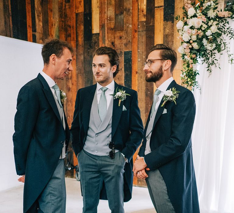 Groom and groomsmen in matching morning suits for the festival barn and marquee wedding at Willow Grange Farm