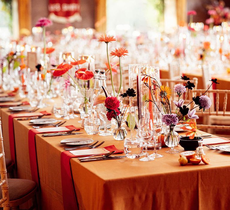 Orange and purple wedding flower and table decorations at Elmore Court country house wedding venue 