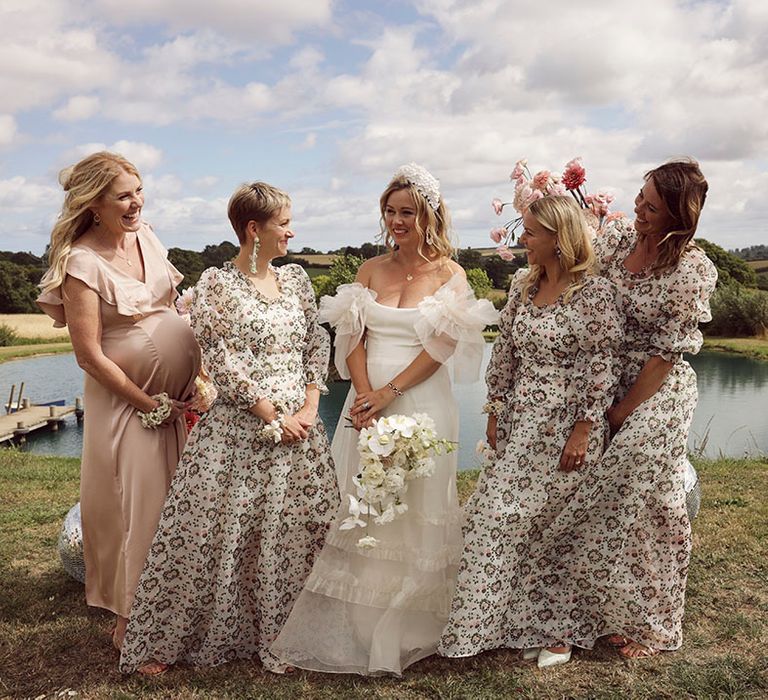 Bridesmaids in puff sleeve patterned dress from Shrimp with bride at outdoor wedding ceremony 